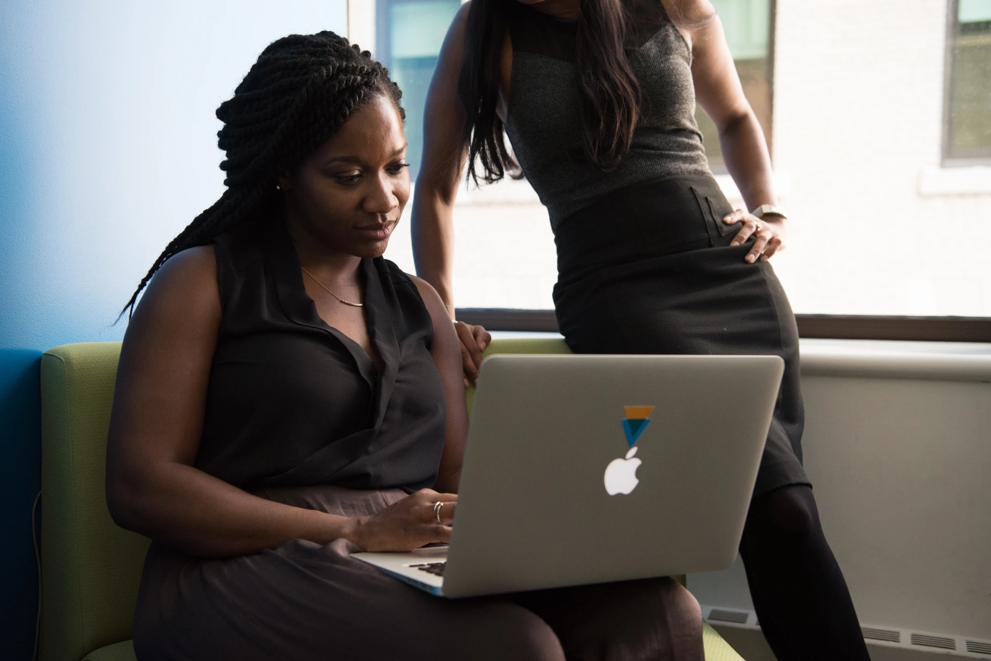Two women looking at laptop