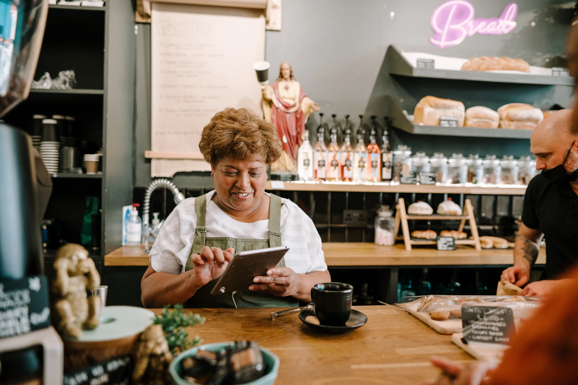 Woman at cafe register stock
